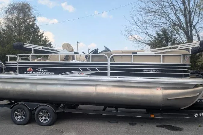 Slide: The Image of 2022 Sun Tracker SportFish 22 XP3 pontoon boat on trailer, parked outdoors. - 12