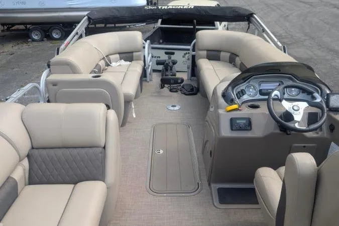 Slide: The Image of Interior view of 2022 Sun Tracker SportFish 22 XP3 pontoon boat with beige seating and helm. - 6