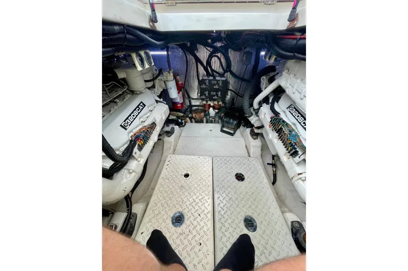 Slide: The Image of Engine room of a 1990 Rampage 36 Express boat with visible machinery and wiring. - 10