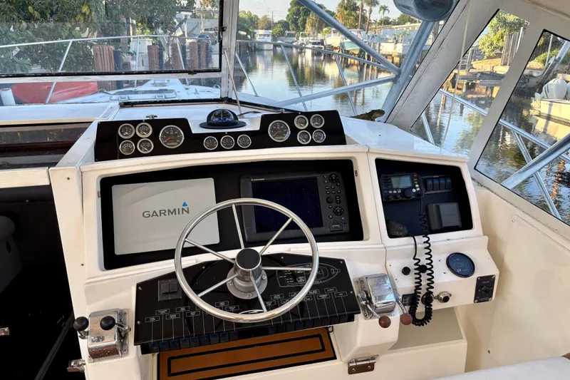 Slide: The Image of Cockpit of 1990 Rampage 36 Express boat with Garmin navigation system and control panel. - 4