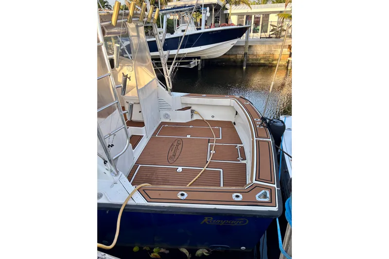 Slide: The Image of 1990 Rampage 36 Express boat with teak deck, docked at marina. - 6