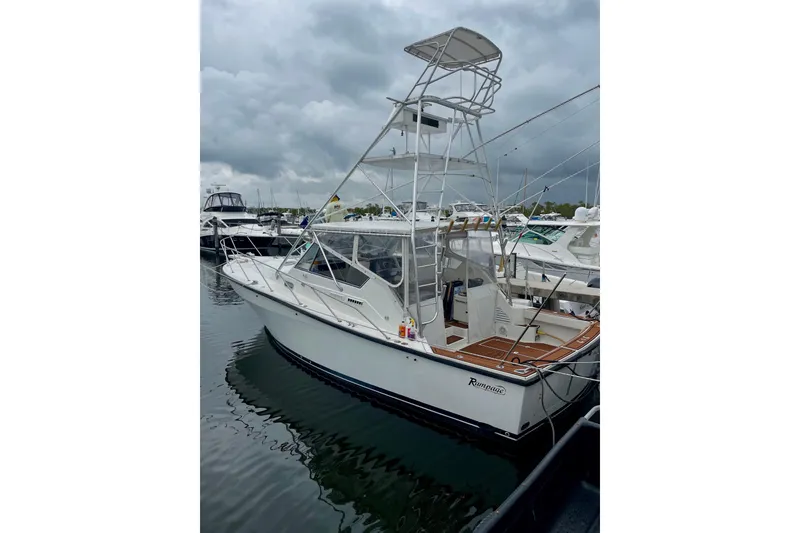 Slide: The Image of 1990 Rampage 36 Express boat docked at marina under cloudy sky. - 8