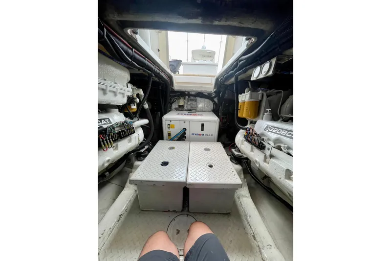 Slide: The Image of Engine room of 1990 Rampage 36 Express boat, featuring dual engines and equipment. - 9