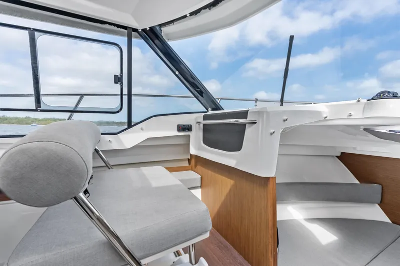 Slide: The Image of Interior of 2020 Jeanneau NC 795 boat with modern seating and panoramic windows. - 12