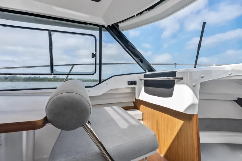 Slide: The Image of Interior view of 2020 Jeanneau NC 795 boat with modern seating and window. - 13