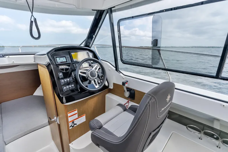 Slide: The Image of Interior view of 2020 Jeanneau NC 795 boat cockpit with steering wheel and controls. - 16