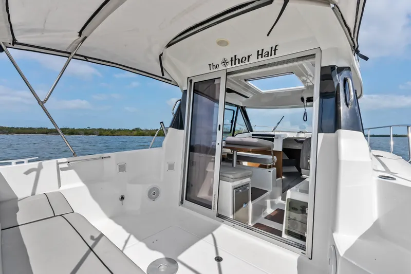 Slide: The Image of 2020 Jeanneau NC 795 boat interior with open sliding door, overlooking calm waters. - 20