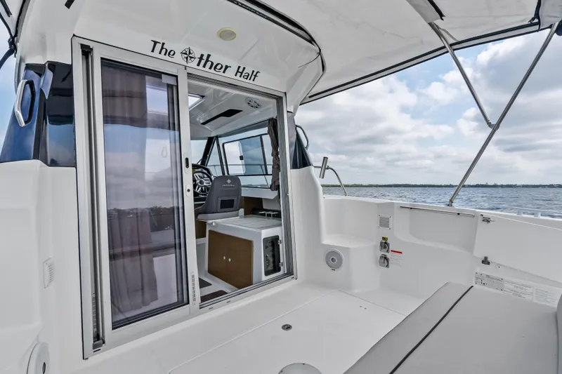 Slide: The Image of 2020 Jeanneau NC 795 boat interior with sliding door, ocean view, and seating area. - 21