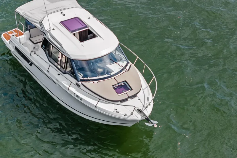 Slide: The Image of 2020 Jeanneau NC 795 boat on clear green water, aerial view. - 3
