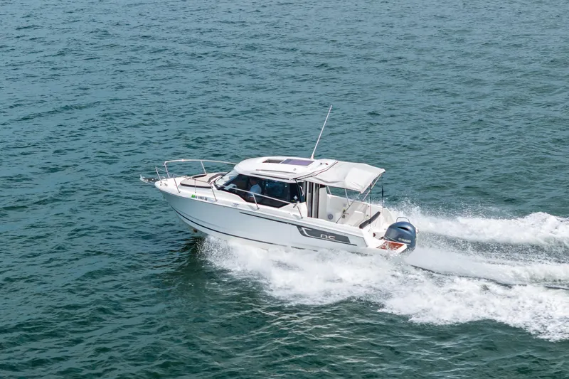 Slide: The Image of 2020 Jeanneau NC 795 motorboat cruising on open water. - 6