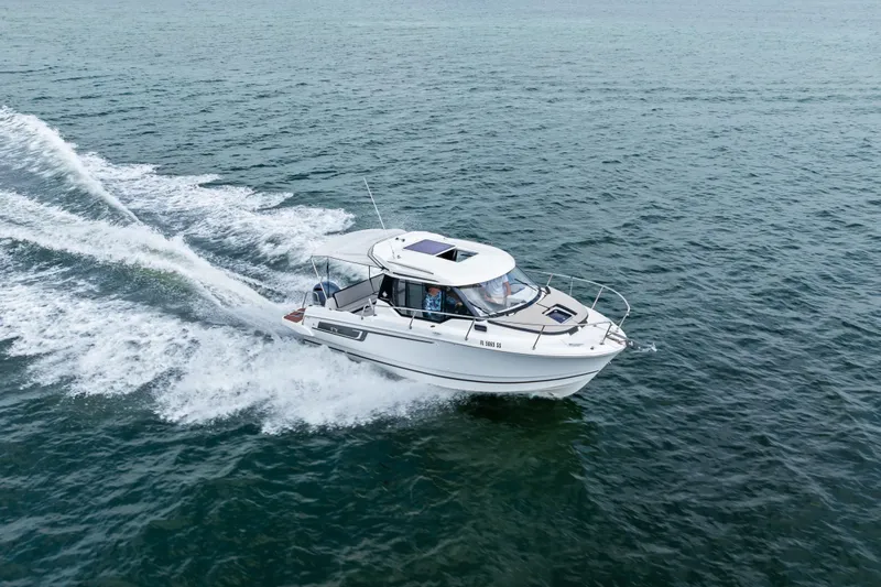 Slide: The Image of 2020 Jeanneau NC 795 motorboat cruising on open water. - 7