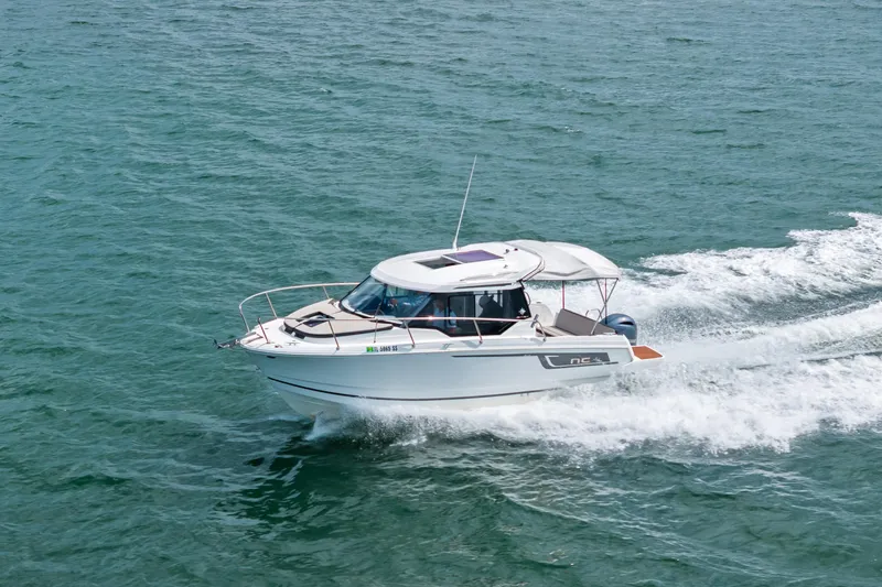 Slide: The Image of 2020 Jeanneau NC 795 motorboat cruising on open water. - 8