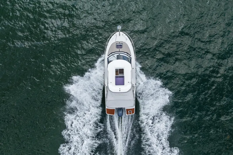 Slide: The Image of Aerial view of 2020 Jeanneau NC 795 motorboat cruising on water. - 9