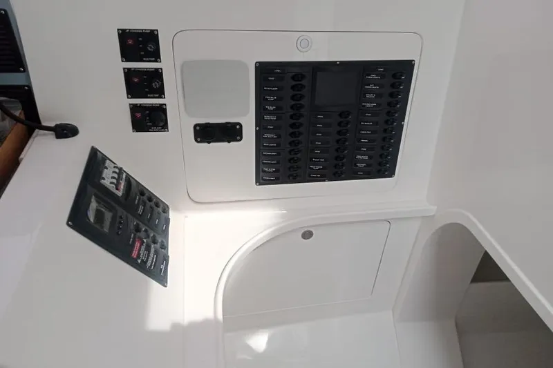 Slide: The Image of Control panel of 2023 Rapido 40 yacht, featuring switches and gauges. - 11