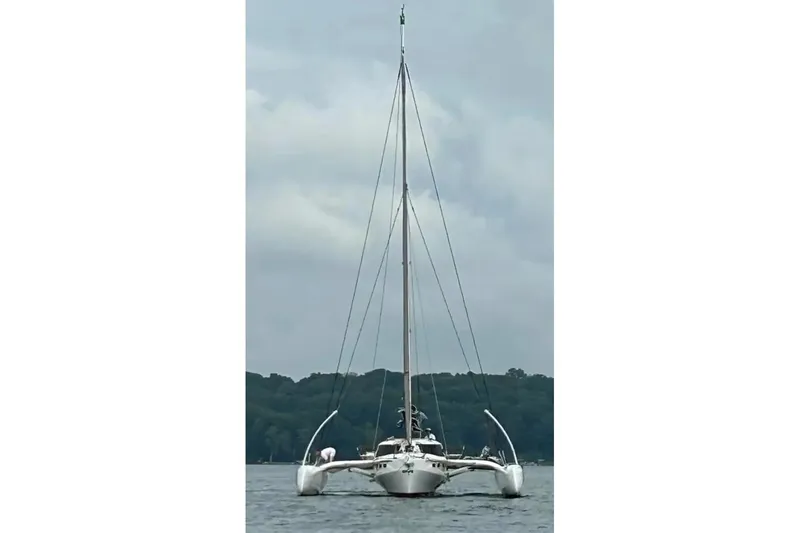 Slide: The Image of 2023 Rapido 40 trimaran sailing on a calm lake under cloudy skies. - 3