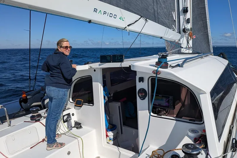 Slide: The Image of Woman sailing on a 2023 Rapido 40 trimaran in open sea. - 4