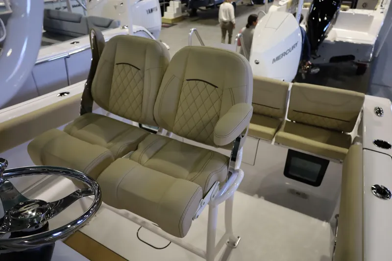 Slide: The Image of 2026 Sportsman Heritage 231 Center Console boat with luxurious seating and steering wheel. - 10