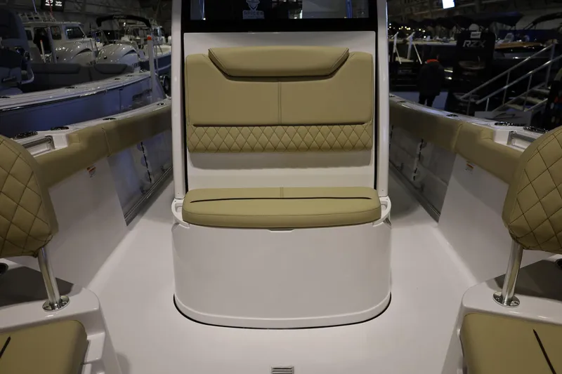 Slide: The Image of 2026 Sportsman Heritage 231 Center Console boat interior with tan cushioned seating. - 11
