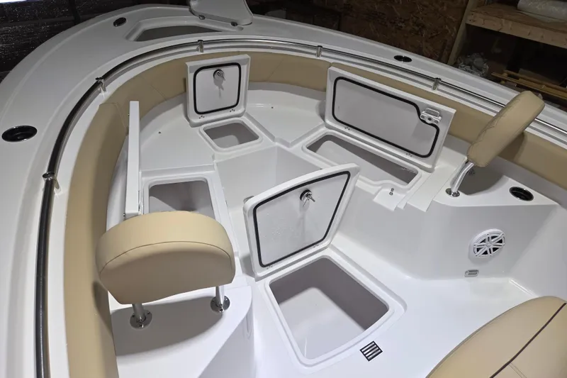 Slide: The Image of 2026 Sportsman Heritage 231 Center Console boat interior with open storage compartments and cushioned seating. - 13