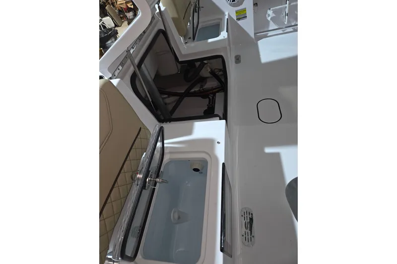 Slide: The Image of 2026 Sportsman Heritage 231 Center Console interior with open storage compartments. - 21