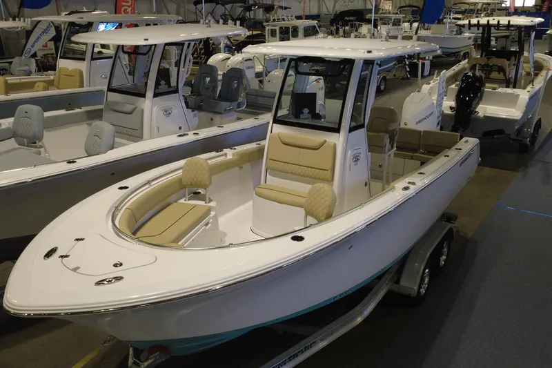 Slide: The Image of 2026 Sportsman Heritage 231 Center Console boat displayed at an indoor showroom. - 3