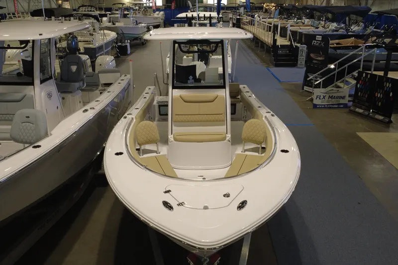 Slide: The Image of 2026 Sportsman Heritage 231 Center Console boat displayed at an indoor showroom. - 4