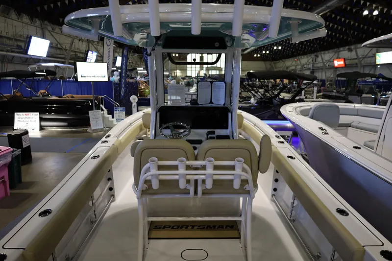 Slide: The Image of 2026 Sportsman Heritage 231 Center Console boat displayed at an indoor boat show. - 5