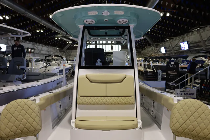 Slide: The Image of 2026 Sportsman Heritage 231 Center Console boat displayed at an indoor boat show. - 6