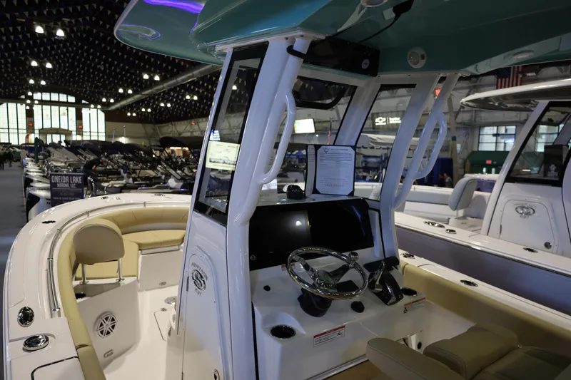 Slide: The Image of 2026 Sportsman Heritage 231 Center Console boat interior at a showroom display. - 8
