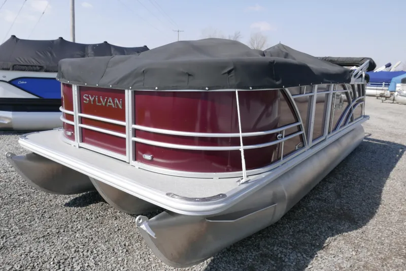 Slide: The Image of 2021 Sylvan Mirage 8520 Cruise pontoon boat with cover, parked on gravel. - 14