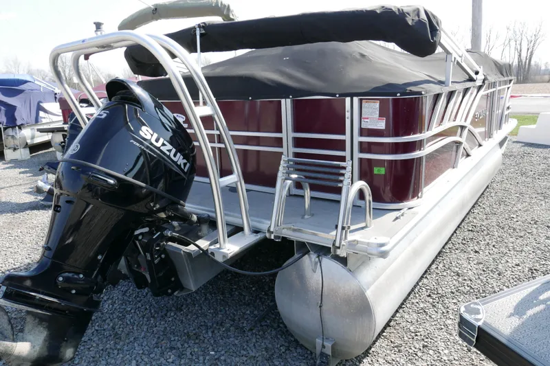 Slide: The Image of 2021 Sylvan Mirage 8520 Cruise pontoon boat with Suzuki outboard motor, covered and parked. - 15