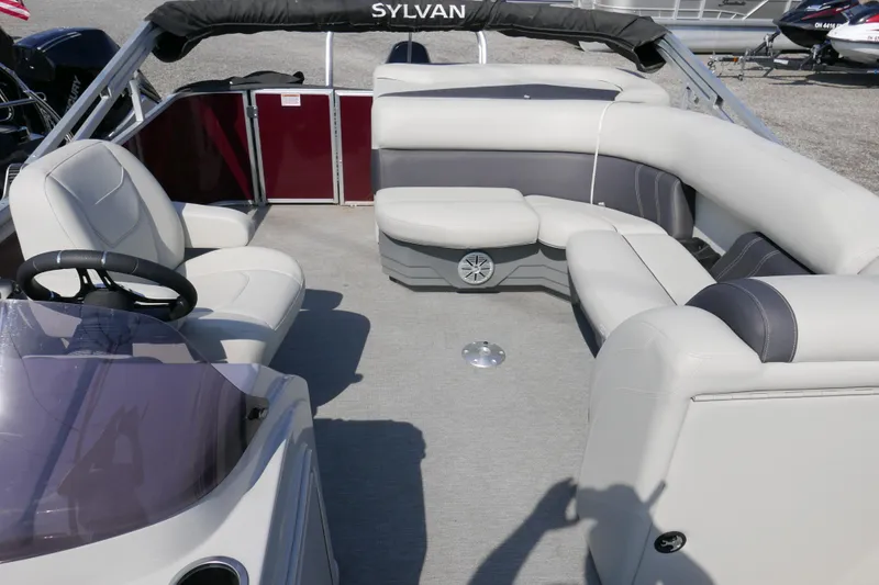 Slide: The Image of 2021 Sylvan Mirage 8520 Cruise pontoon boat interior with plush seating and steering console. - 5
