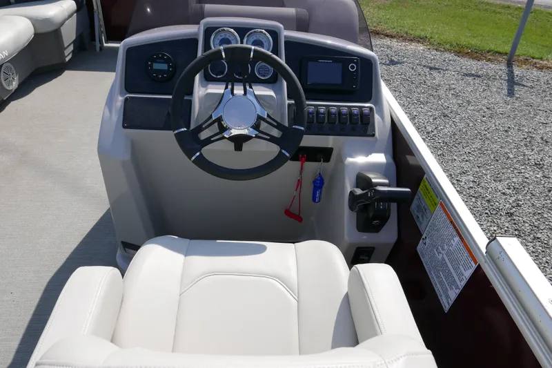Slide: The Image of 2021 Sylvan Mirage 8520 Cruise boat dashboard with steering wheel and controls. - 7