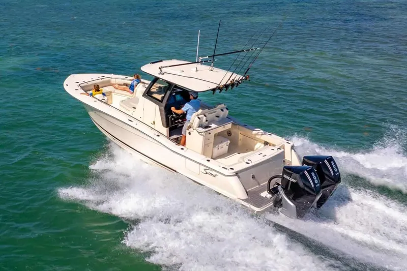 The Image of Manufacturer Provided Image: 2026 Scout 288 LXF boat cruising on open water with passengers onboard. - 0