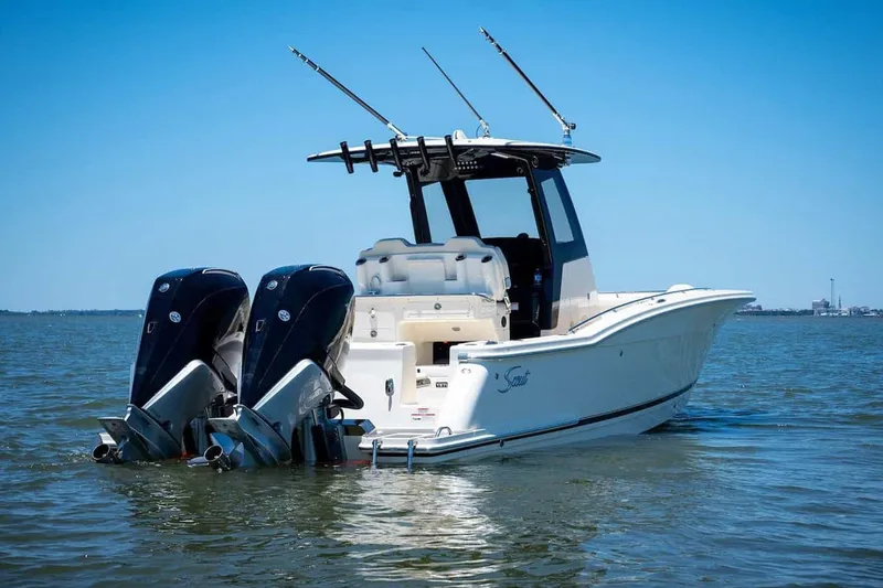 Slide: The Image of Manufacturer Provided Image: 2026 Scout 288 LXF boat with dual engines on calm water. - 2