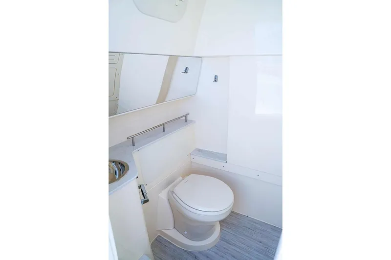 Slide: The Image of Manufacturer Provided Image: 2026 Scout 288 LXF boat bathroom interior with toilet and sink. - 8
