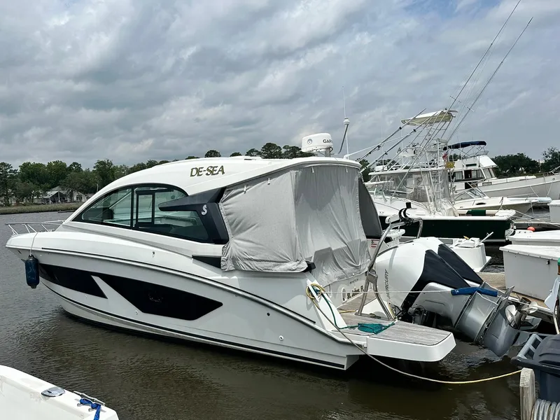 The Image of 2021 Beneteau GT 32 boat docked at marina under cloudy sky. - 0