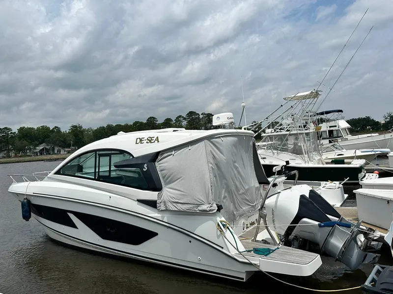 Slide: The Image of 2021 Beneteau GT 32 yacht docked at marina under cloudy sky. - 1