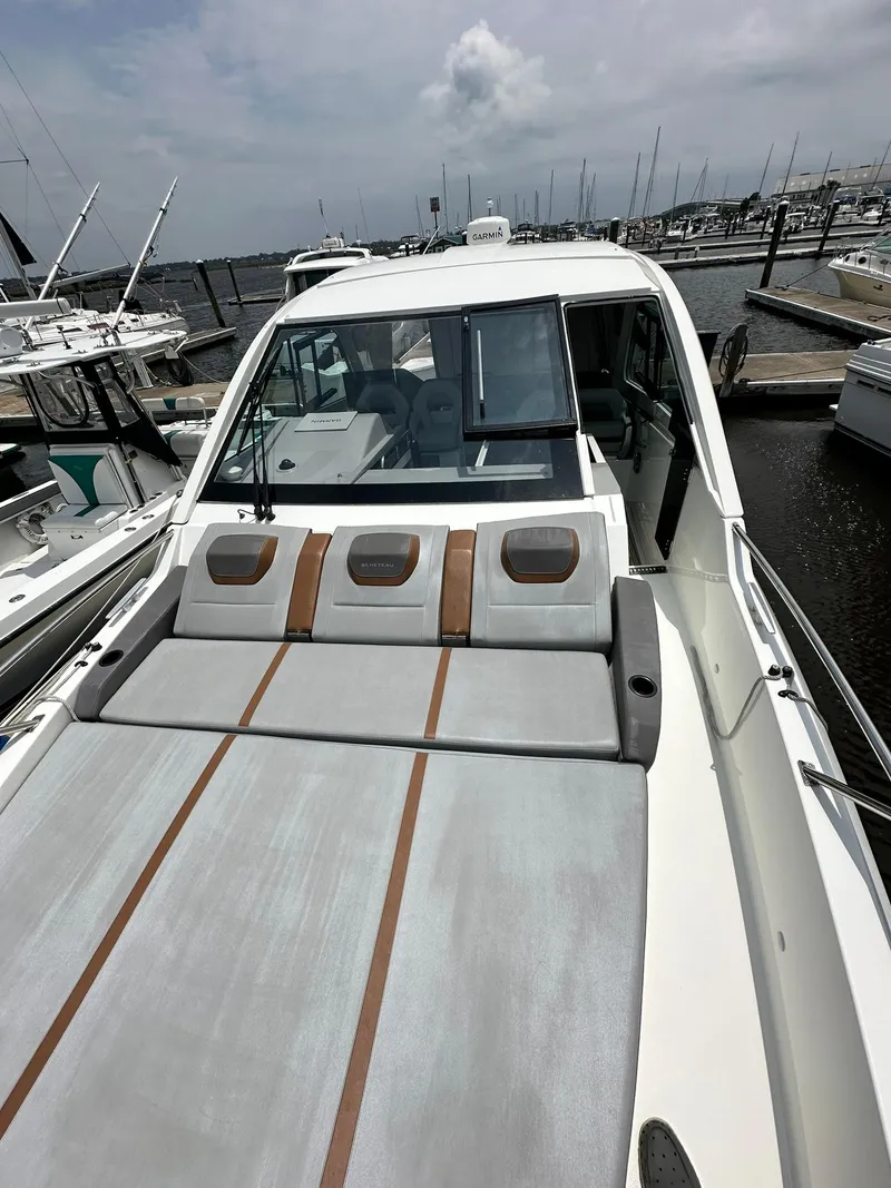 Slide: The Image of 2021 Beneteau GT 32 yacht with sleek deck design, docked at marina. - 12