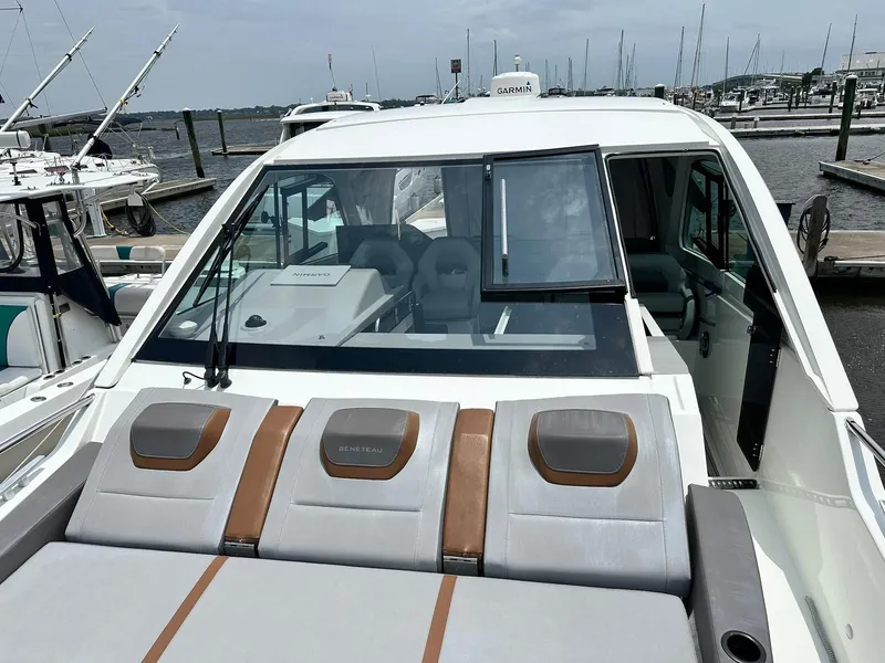 Slide: The Image of 2021 Beneteau GT 32 yacht with sunbathing area, docked at marina. - 14