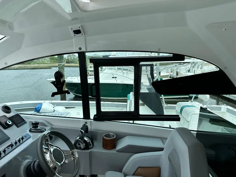 Slide: The Image of Interior view of 2021 Beneteau GT 32 yacht cockpit with steering wheel and window. - 26