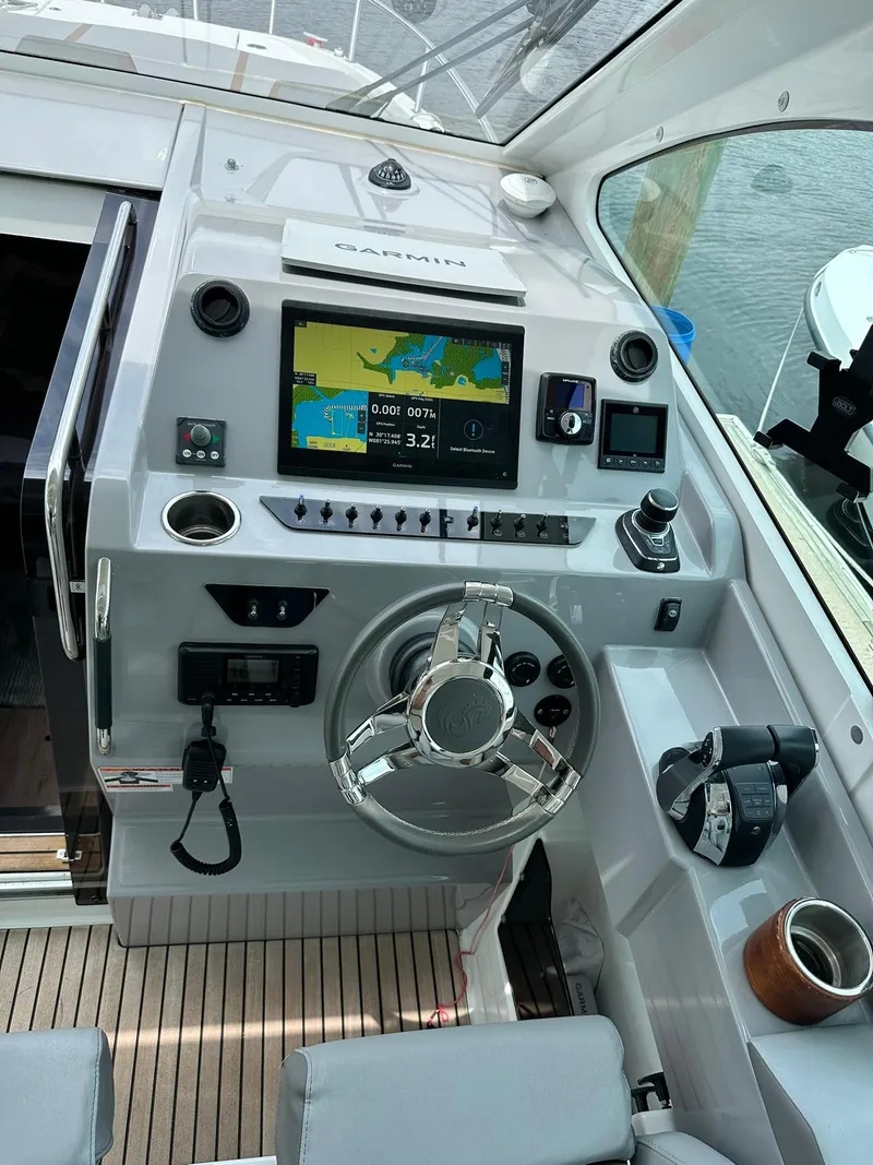 Slide: The Image of 2021 Beneteau GT 32 helm with Garmin navigation system and modern controls. - 29
