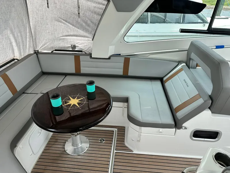 Slide: The Image of 2021 Beneteau GT 32 yacht interior with cushioned seating and table. - 30