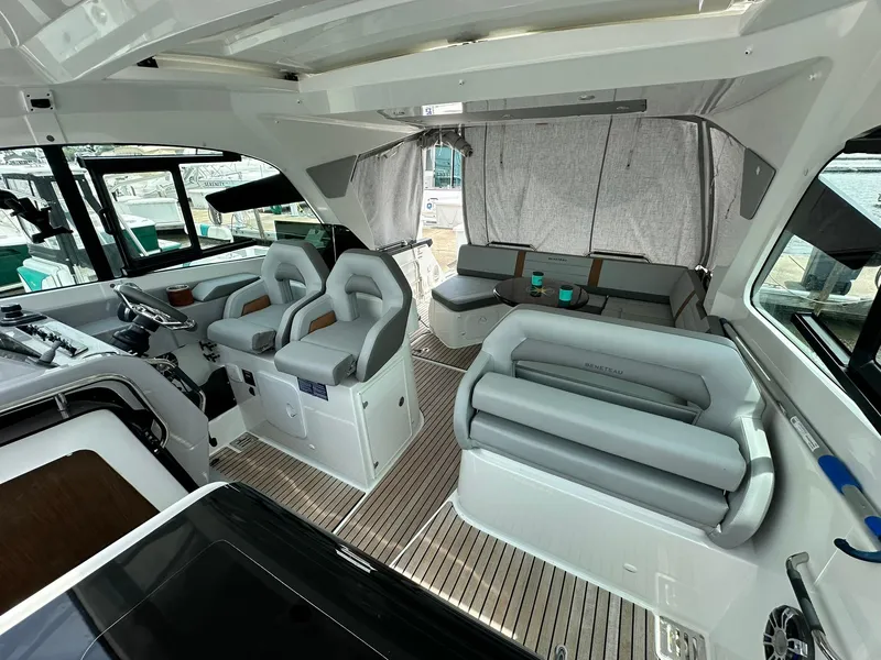 Slide: The Image of 2021 Beneteau GT 32 interior with modern seating and helm, featuring sleek design and spacious layout. - 37