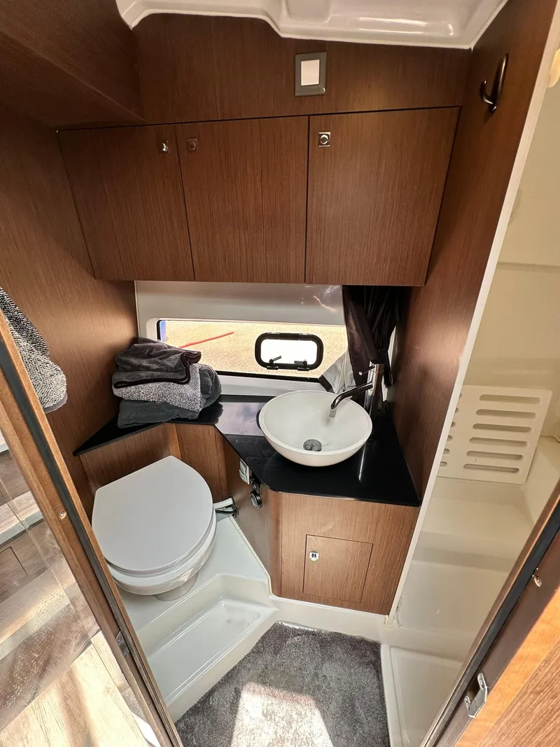 Slide: The Image of 2021 Beneteau GT 32 bathroom with modern fixtures, wooden cabinetry, and compact design. - 45