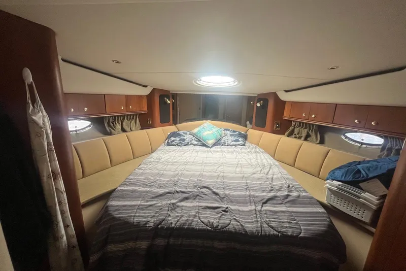Slide: The Image of Luxurious cabin interior of 2000 Cruisers Yachts 5000 Sedan Sport with cozy bedding. - 10