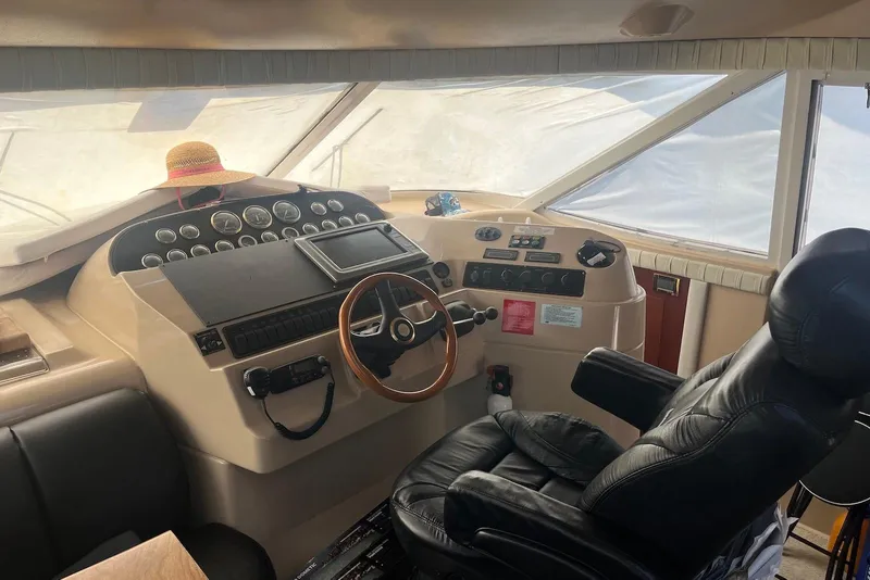 Slide: The Image of Interior helm of 2000 Cruisers Yachts 5000 Sedan Sport with leather captain's chair. - 2
