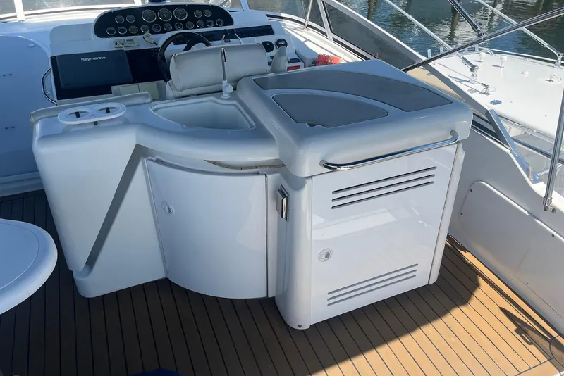 Slide: The Image of Cockpit view of 2000 Cruisers Yachts 5000 Sedan Sport with helm and seating area. - 5