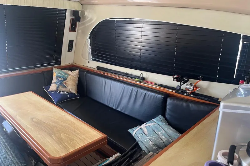 Slide: The Image of Interior of 2000 Cruisers Yachts 5000 Sedan Sport with cozy seating and fishing gear. - 7