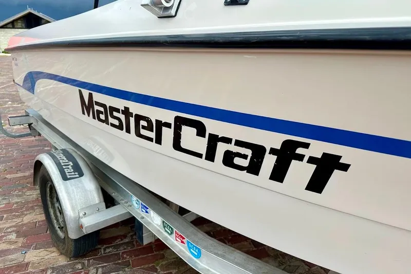Slide: The Image of 1998 MasterCraft SportStar 19 boat on trailer, showcasing brand logo and design. - 11